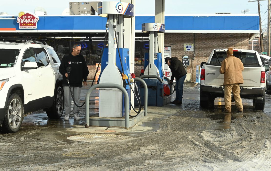 Gas prices fall to four-year lows as millions embark on holiday road trips