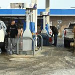 Gas prices fall to four-year lows as millions embark on holiday road trips